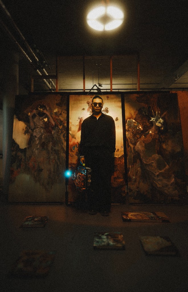 Sparro Chen in studio with modular synthesizer and paintings